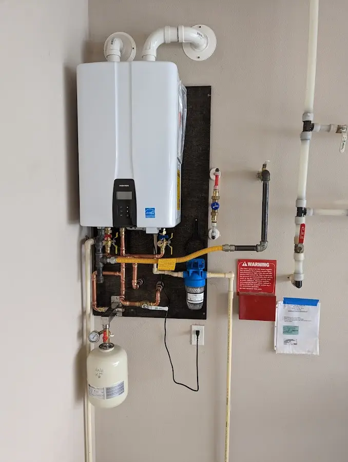 Professional plumber installing copper piping in a West View home